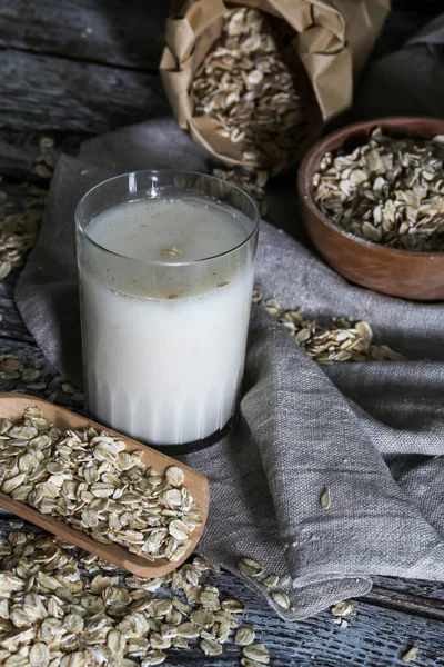 A oats drink, Vegatorian alternative to milk and oatmeal on a rustic table