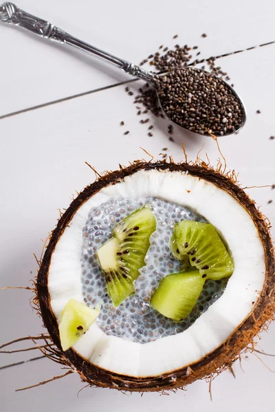Chia zaden pudding met kiwi fruit in de shell van een kokosnoot — Stockfoto