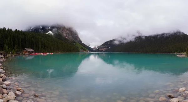 Panoramic landscape of the Louise Lake. Rainy and cloudy day.