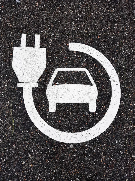 Electric car charger icon on the road. Close up