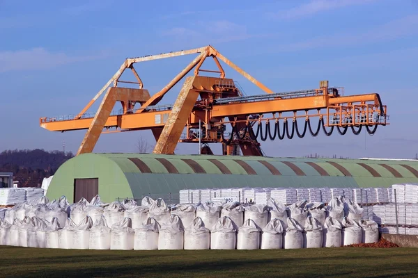 Crane with warehouse and bulk bags — Stock Photo, Image