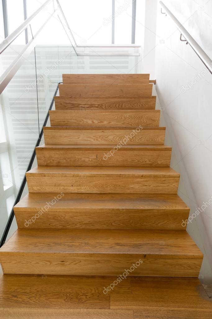 Wooden stairs, white wall, inox and glass handrail. over exposed.