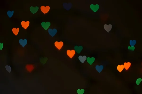 Hintergrund mit farbigem Bokeh. Hintergrund zum Valentinstag — Stockfoto