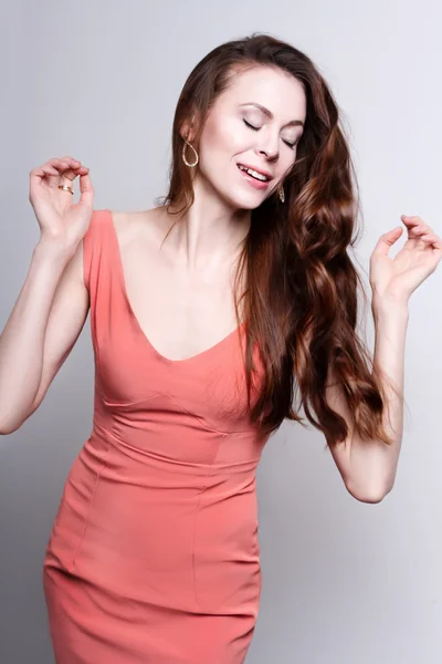 Young attractive dancing woman with beautiful long brown hair — Stok fotoğraf