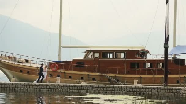 Wedding couple running on the berth with holding hands  in Montenegro, Budva — Stock Video