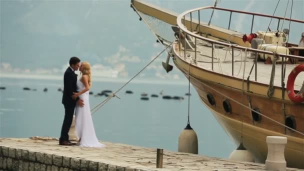 Bride and groom kissing on the berth in Montenegro, Budva — Stock Video