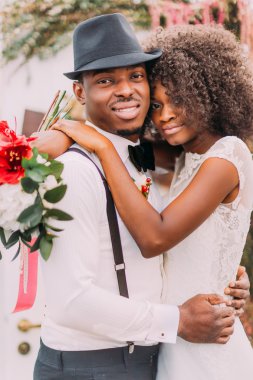 Happy black wedding couple smiling into the camera