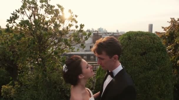 Charming brunette bride and groom kiss. Romantic Paris on background — Stock Video