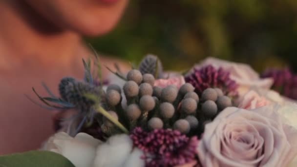 Beautiful bride with wedding bouquet in hands close up — Stock Video