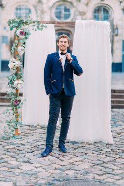 Şık Damat Düğün kemer arka plan üzerinde ile poz