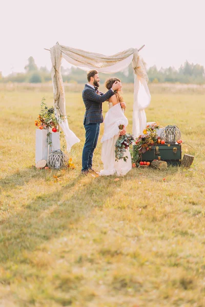 Bonito noivo fechar os olhos para sua noiva na cerimônia de casamento — Fotografia de Stock