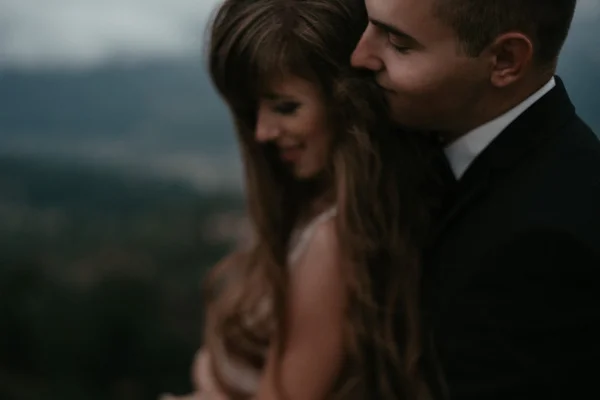 Beautiful bride and handsome groom at wedding day lovely hugging outdoors on nature. — Stock Photo, Image