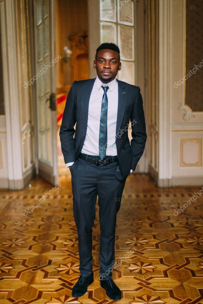 Handsome Groom In Black Suit Posing Luxurious Hotel Room