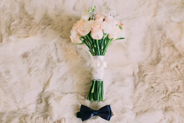 Acessórios de casamento: laço azul do noivo, buquê de rosas nupciais na pele branca . — Fotografia de Stock