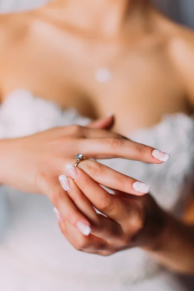 Beautiful bride in white dress putting expensive engagement ring — Stock Photo, Image