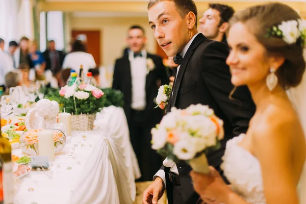 Handsome groom holding redemption of bride on wedding indoors — 스톡 사진