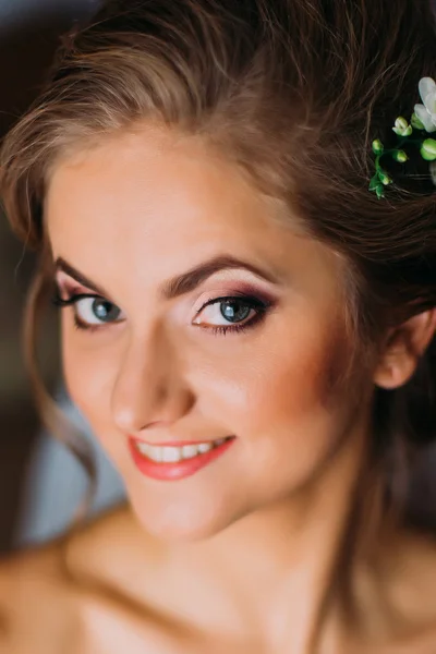Close-up portrait of beautiful young happy smiling woman with blond hair and delicate make-up Stock Picture