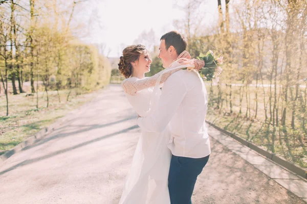 Sensual wedding couple, groom and bride, holding each other laughing — Stock Photo, Image