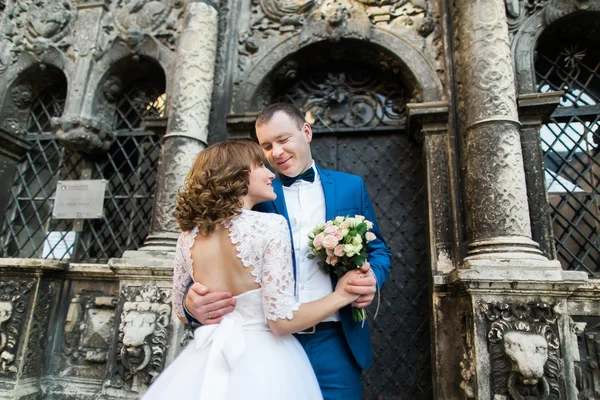 Sensual pareja recién casada abrazándose cerca de edificio viejo con columnas —  Fotos de Stock