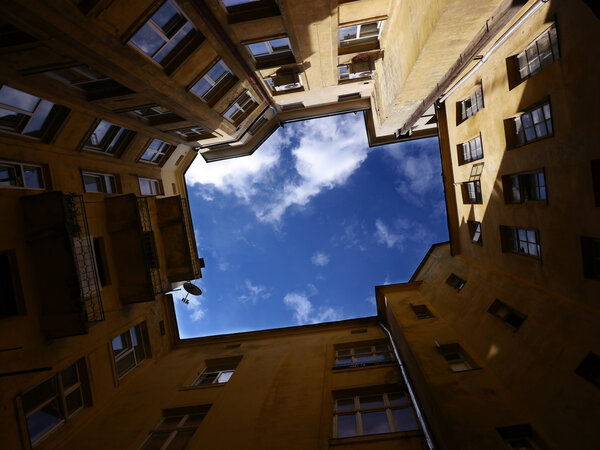 Cloudy sky seen from the closed quadrangle well courtyard in Lviv, Ukraine.