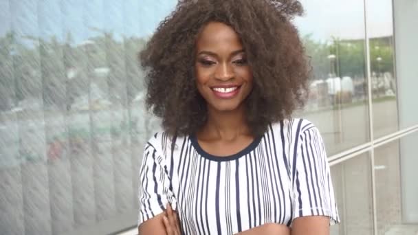 Beautiful sexy sensual young african american woman charmingly smiling on the glass wall background close-up — Stock Video