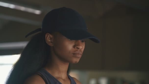 Close-up of black pretty african-american woman walking on a treadmill in the gym — Stock Video