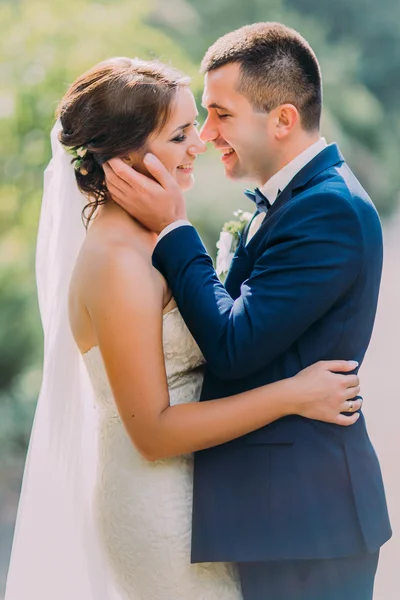 Romantic just married couple holding each other outdoor at sunny day — Stock Photo, Image