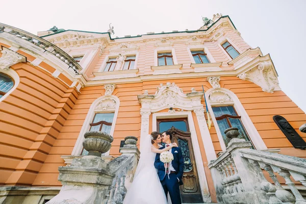 Casal jovem bonito nas escadas do palácio antigo romântico — Fotografia de Stock