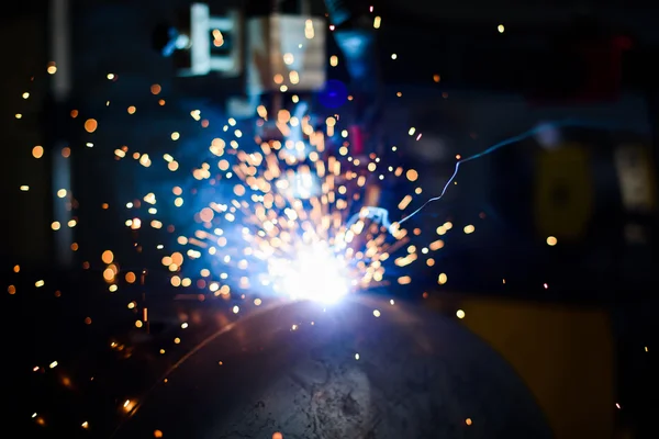 Metal grinding with bright orange and blue flying sparks — Stock Photo, Image