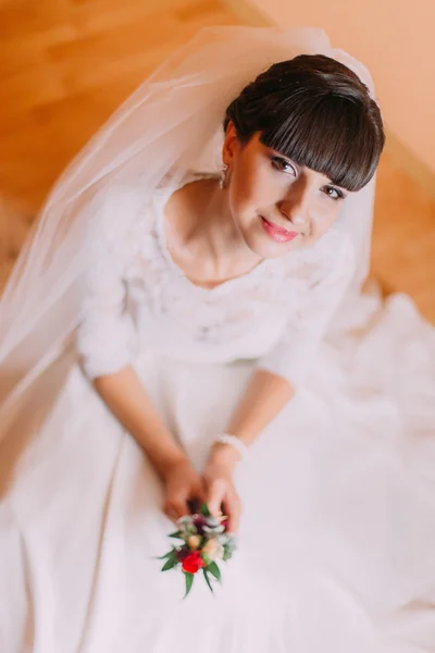 Encantadora novia en precioso vestido blanco esperando su boda posando con lindo boutonniere floral —  Fotos de Stock