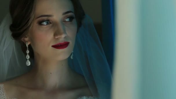 Портрет красивой невесты, смотрящей в окно вблизи — стоковое видео