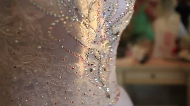 Détail robe de mariée. Gros plan de la décoration strass fantaisie sur robe blanche luxueuse — Video