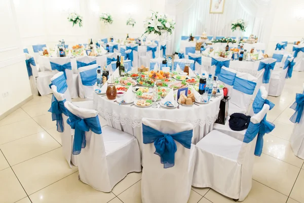 Conjunto de mesa de restaurante para bodas de lujo en salón luminoso. Enfoque en sillas decoradas —  Fotos de Stock