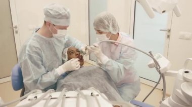Scrup Kupası diş kliniğinde tıbbi prosedürler Bayan hasta yapma dişçi ile kalfa giyen üniforma