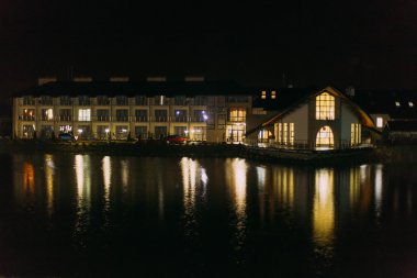 Göl yansıtma sarı pencere ışığı yansımaları ile geceleri otel binası