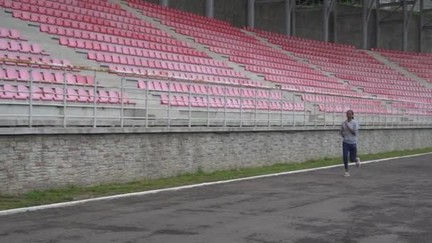 Atractiv tânăr african american femeie în unelte de fitness gri face formare la stadion — Videoclip de stoc