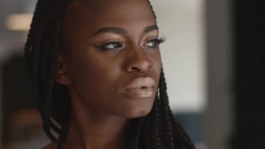 Aşırı yakın çekim güzel genç Afro-Amerikan kadın moda model kapalı poz ve bir şey için bekler