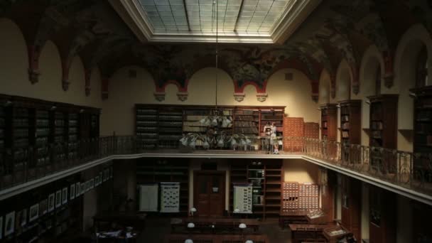 Romantic Young Couple Kissing On Cheeks In The Vintage Library While Reading Books — Stock Video