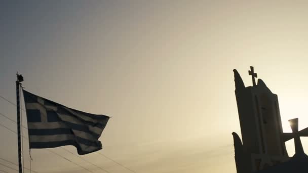 Oia, サントリーニ, ギリシャの青い海でギリシャの旗の白い教会の上部. — ストック動画