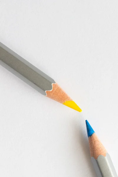 Blue and yellow pencils on a white background — Stock Photo, Image