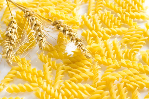 Wheat and pasta on  white background — Stock Photo, Image