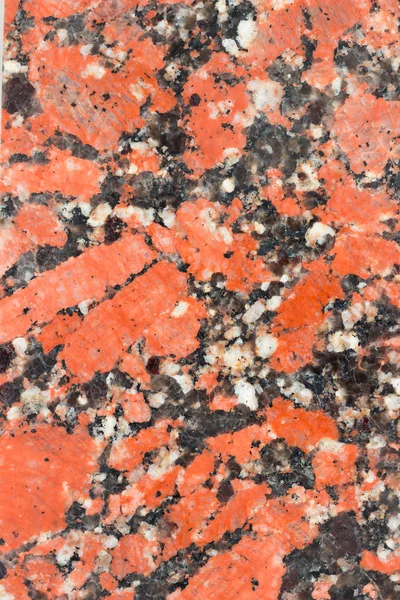 Red and black granite. The texture of natural stone