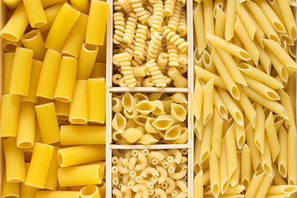 Different kinds of pasta in  wooden box — Stock Photo, Image