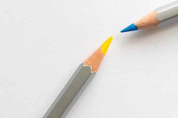 Blue and yellow pencils on a white — Stock Photo, Image