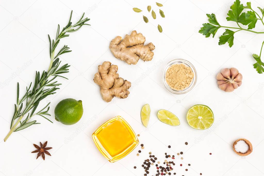 Ginger, rosemary sprig, tea and lime. Treatment of colds and flu.  White background. Flat lay