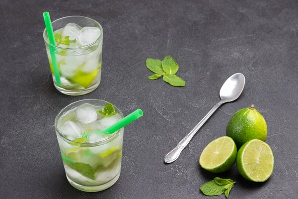 Two Glasses Iced Lemon Drink Lime Spoon Table Black Background — Stock Photo, Image