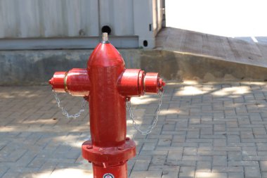 Photo of a red hydrant, this tool is for extinguishing fires if there is a fire, a hydrant is a pump for fire extinguishers