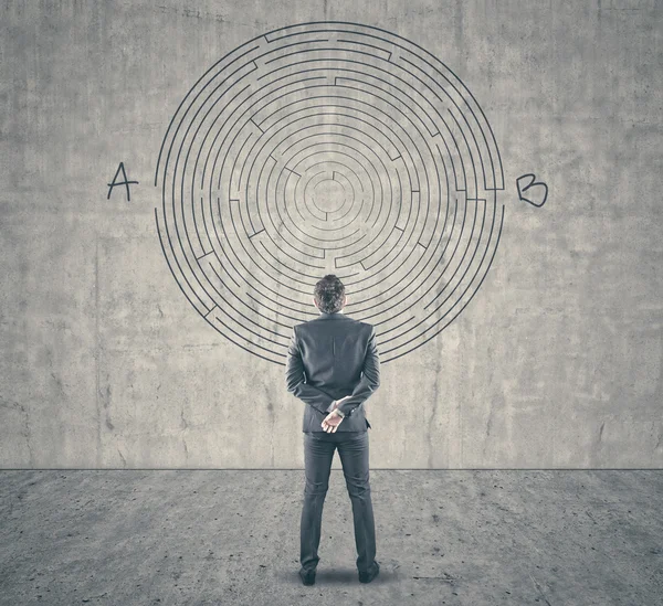 Empresario mirando un laberinto en la pared — Foto de Stock