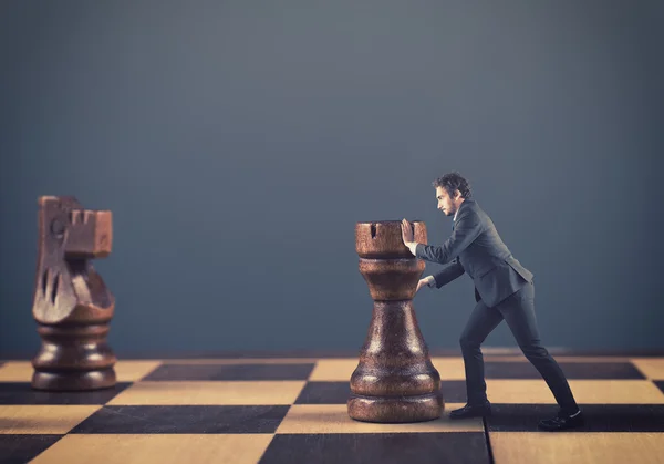 Adam satranç taşları iterek