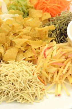 Özel yemek sırasında Çin yeni yılı Yusheng veya Yee Sang adı verilen